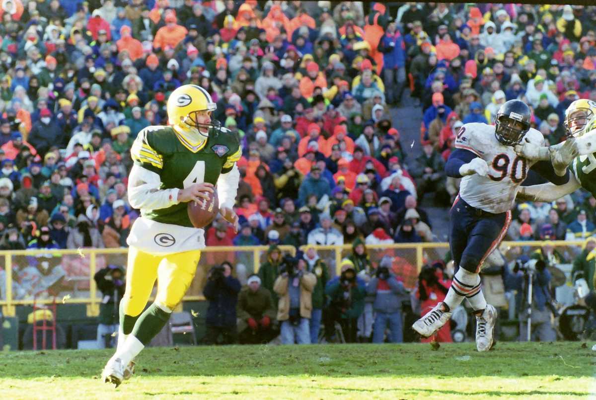 Green Bay Packers quarterback Brett Favre (4) looks to pass as Chicago Bears defensive back Alonzo Spellman (90) approaches. The Packers defeated the Chicago Bears 40-3 on Dec. 11, 1994, at Lambeau Field in Green Bay, Wis. Gpg Historical Packers Vs Bears 08182022 0012